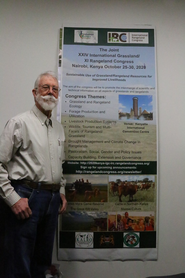 Dr. Jim O’Rourke poses next to his presentation board.